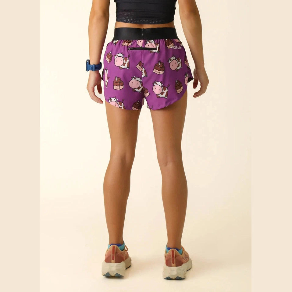 Person wearing purple Chicknlegs 1.5" Split Shorts – Women's with cartoon character pattern on a beige background