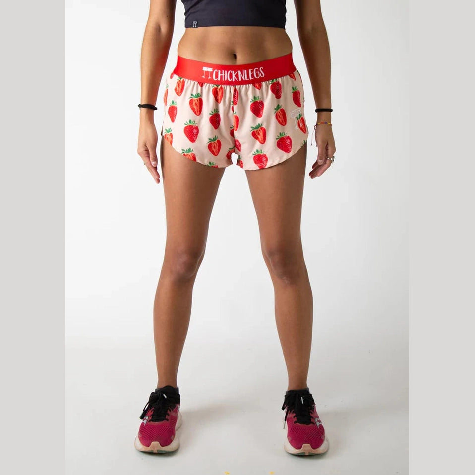 Person wearing strawberry-patterned Chicknlegs 1.5" Split Shorts – Women's with a red waistband on a white background