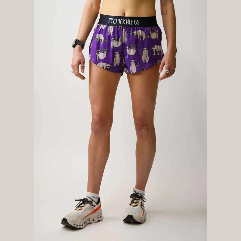 Person wearing purple Chicknlegs 1.5" Split Shorts – Women's with a pattern and black waistband on a white background