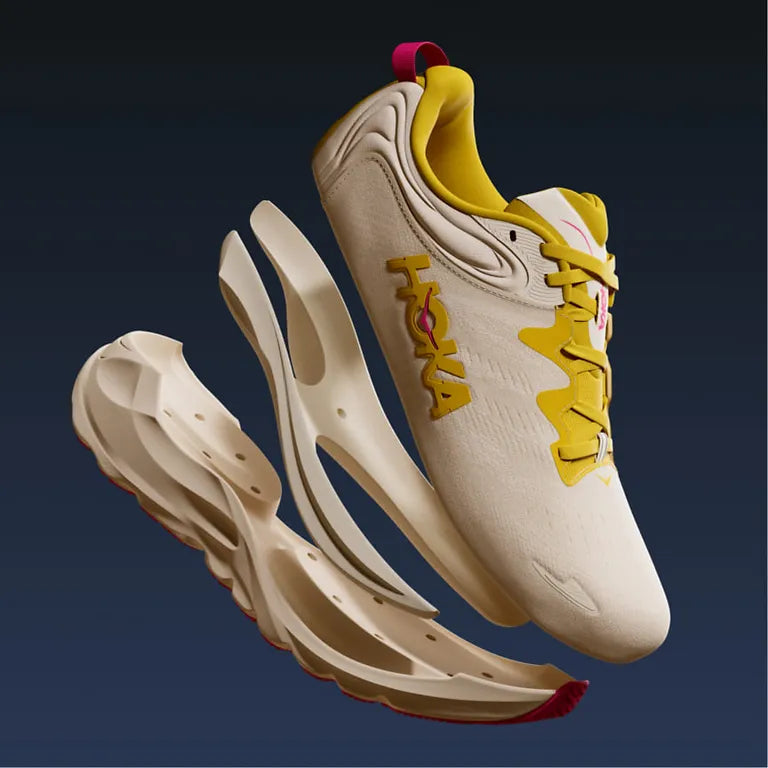 Beige Hoka  Gaviota 6 sneaker with yellow accents and H frame on a dark background