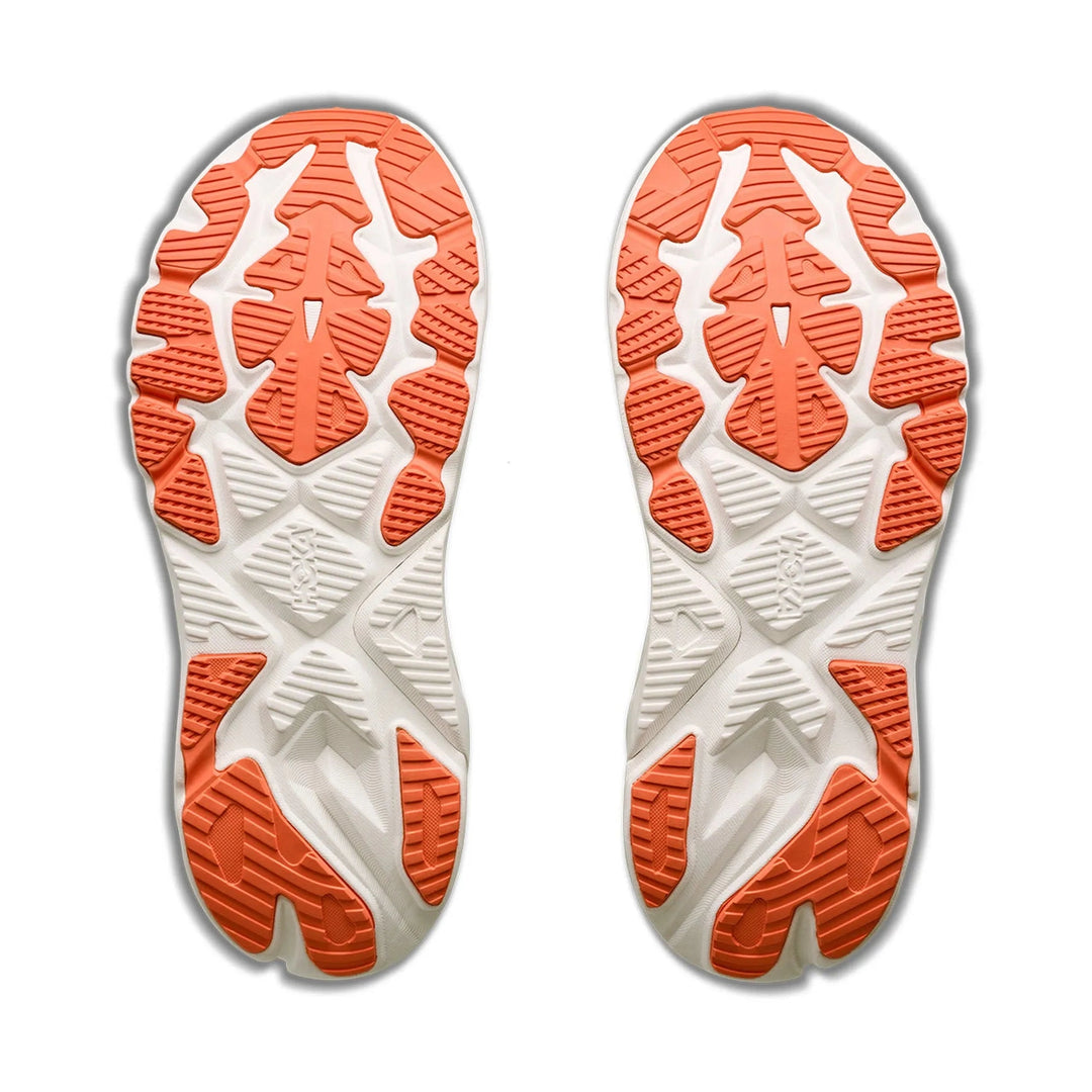 A pair of athletic shoe soles shown from the bottom, featuring a white and orange tread pattern on a plain white background.