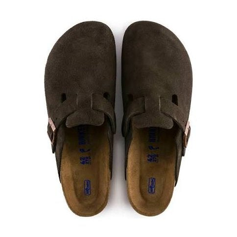 A pair of dark brown suede Birkenstock Boston Soft Footbed clogs with adjustable hook-and-loop straps and a tan footbed, shown from a top-down view on a white background.