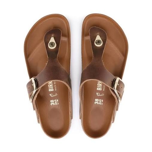 A pair of BIRKENSTOCK Gizeh Big Buckle sandals shown from a top-down view on a white background. The sandals feature a medium brown leather strap with a silver buckle and a contoured footbed.