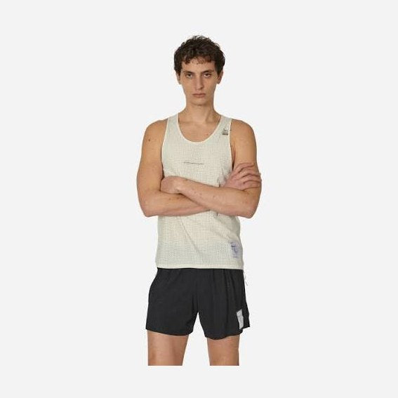 A male model wearing a light beige textured Space-O Singlet--Men's and black athletic shorts, standing against a solid light gray background.