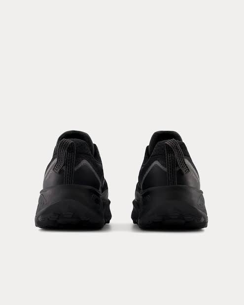 A pair of black New Balance Fresh Foam X Hierro V9 sneakers shown from the back, positioned side-by-side against a light gray background.