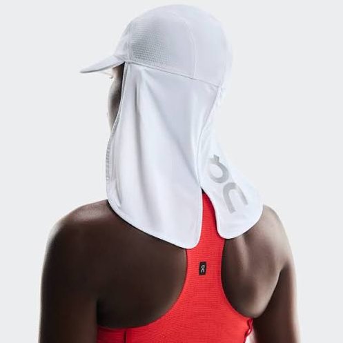 Person wearing On Running Solar Cap on a plain background