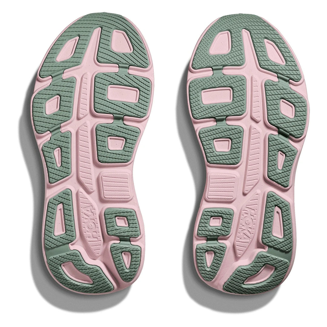 A pair of athletic shoe soles shown from above on a white background, featuring a dual-tone design with dusty pink and sage green textured sections.