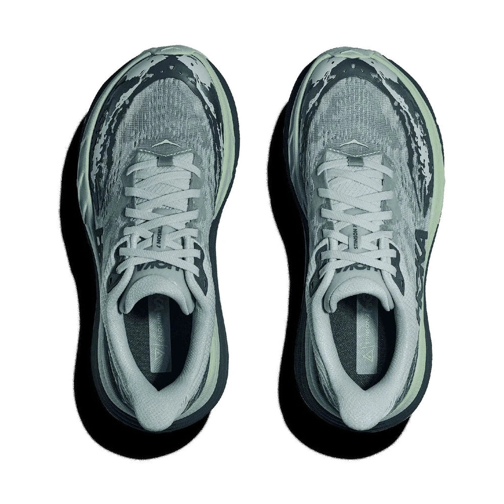 A pair of Hoka Stinson 7 – Women's athletic sneakers shown from a top-down view on a white background, featuring a textured gray and black mesh upper with a light gray laces and collar, and a dark sole.