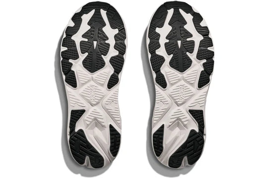 A pair of athletic shoes shown from the sole view, featuring a black and white treaded outsole design on a white background.