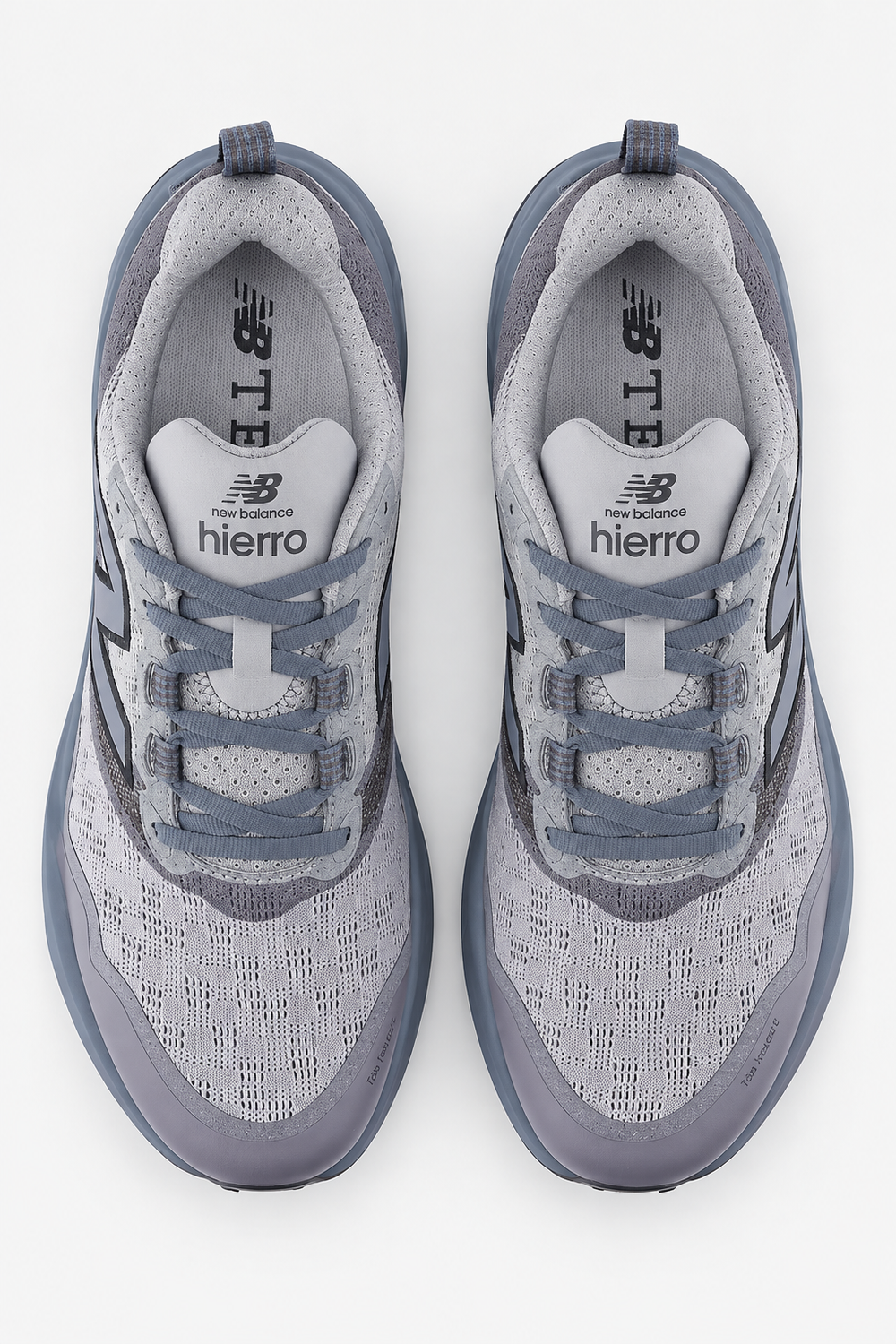 A pair of New Balance Fresh Foam X Hierro V9 – Men's running shoes in gray and slate blue, shown from a top-down view on a light gray background.