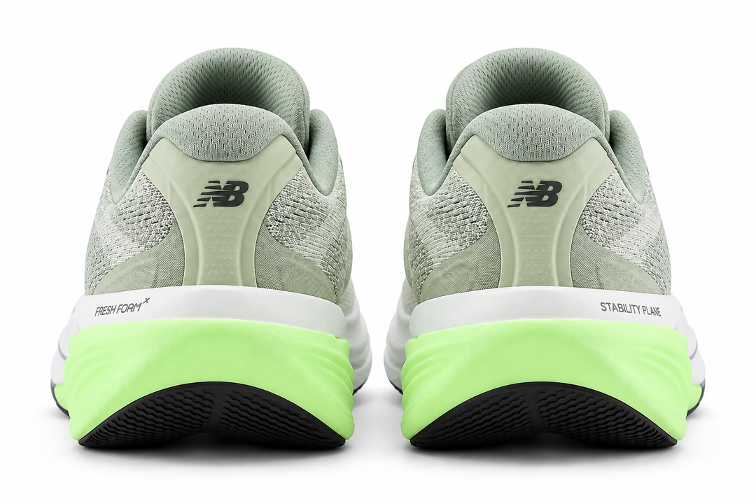 A pair of New Balance Fresh Foam X 860 V15 running shoes shown from the rear, featuring a light sage green upper, a thick white midsole, and a bright neon green outsole.
