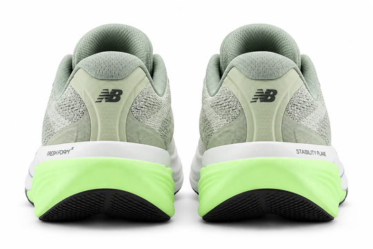 A pair of New Balance Fresh Foam X 860 V15 running shoes shown from the rear, featuring a light sage green upper, a thick white midsole, and a bright neon green outsole.