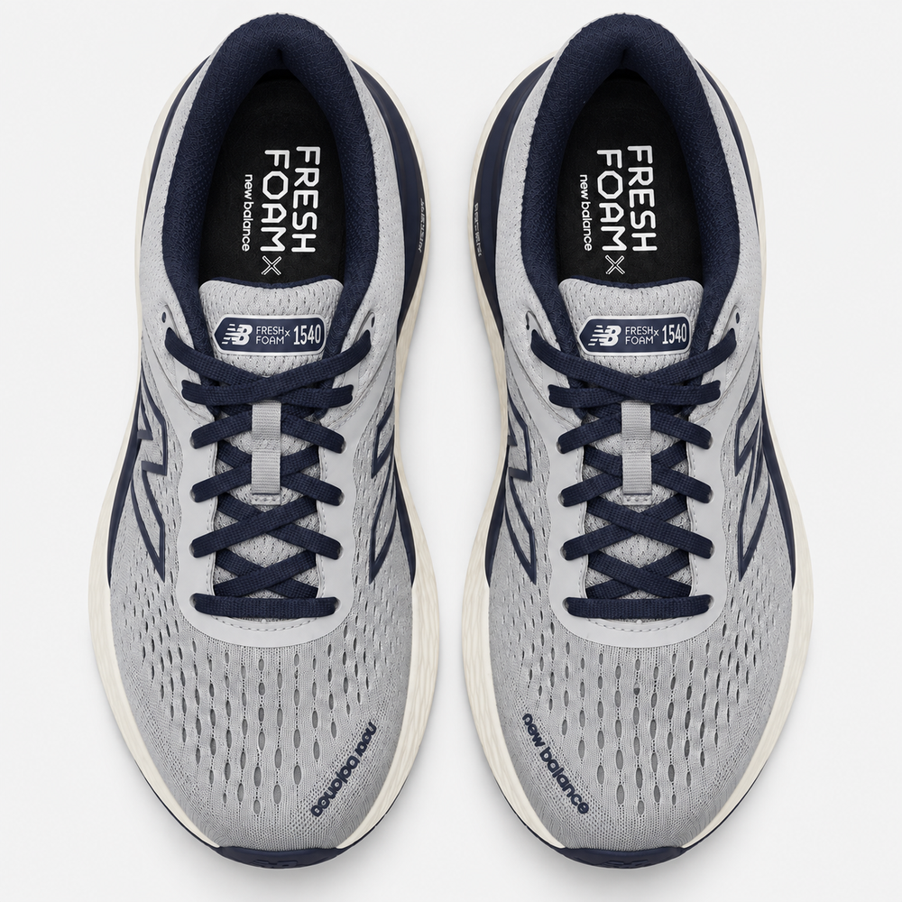 A pair of New Balance Fresh Foam X 1540 running shoes shown from a top-down view on a light gray background. The shoes feature a light gray and white mesh upper with navy blue laces, collar lining, and side accents, and a white midsole.