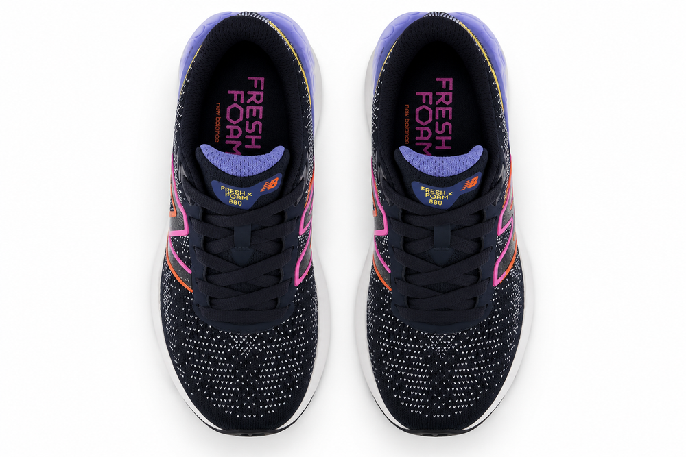 A pair of New Balance Y 880 V12 – Kids' running shoes shown from a top-down view on a white background. The shoes feature a black mesh upper with purple, pink, and orange accents, black laces, and a white midsole.