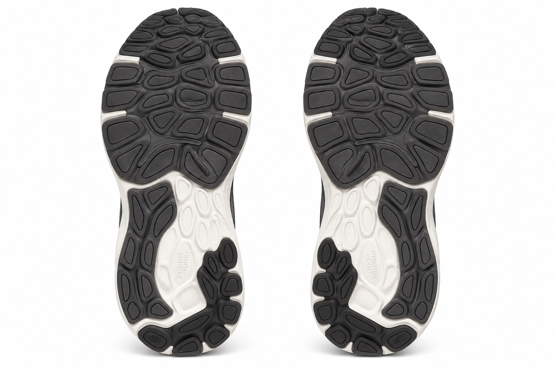 The outsoles of a pair of athletic sneakers, shown from the bottom view against a solid white background.