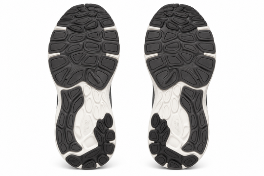 The outsoles of a pair of athletic sneakers, shown from the bottom view against a solid white background.