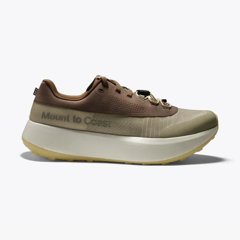 A single Mount to Coast H1 -- Men's  shoe shown in profile against a light gray background. The shoe features a brown upper with a textured olive-green toe box, a thick off-white midsole, and a yellow-tinted outsole.