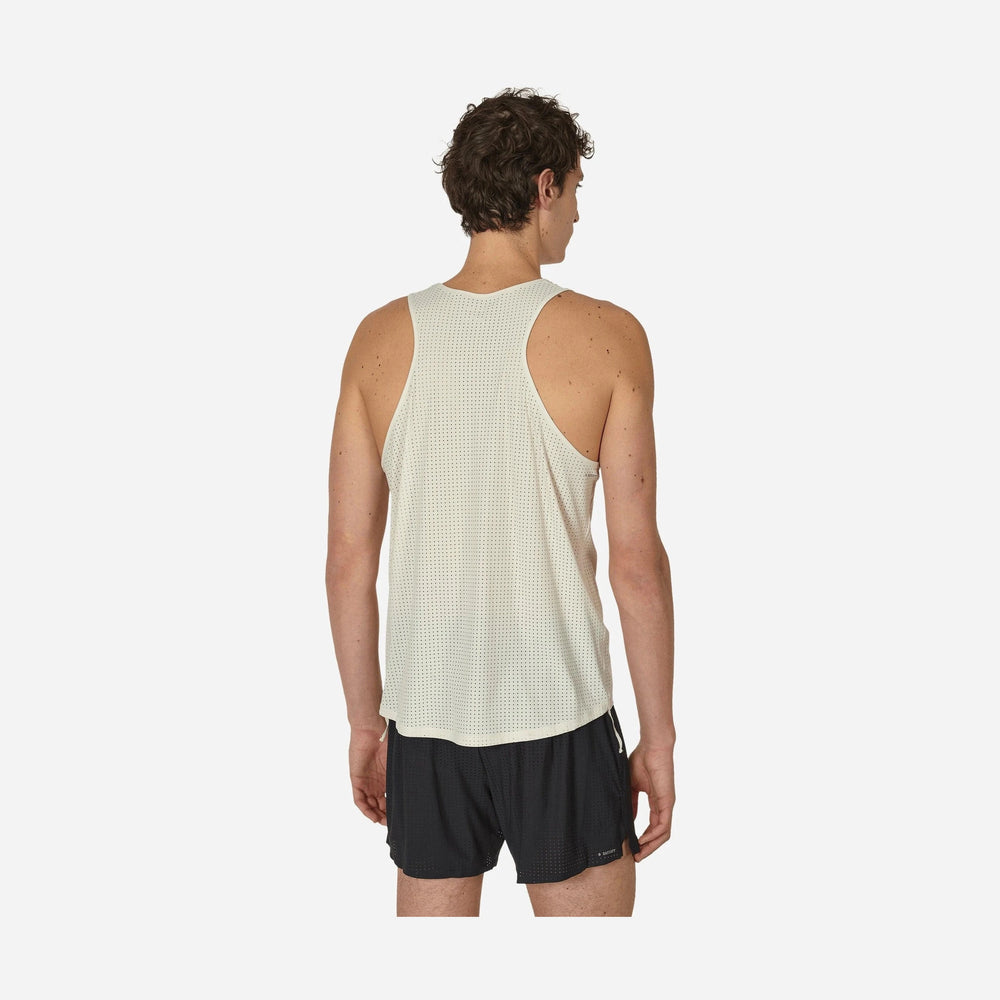 A man shown from the back wearing a light beige mesh Space-O Singlet--Men's and black running shorts against a light gray studio background.
