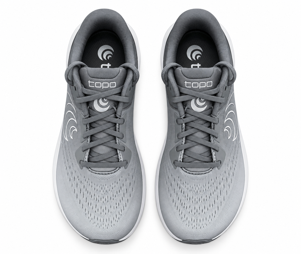 A pair of gray and white Topo Athletic Phantom 4 – Women's – Grey/Grey running shoes shown from a top-down view on a plain white background. The shoes feature a breathable mesh upper, gray laces, and the 'topo' brand name printed on the tongue.