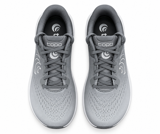 A pair of gray and white Topo Athletic Phantom 4 – Women&