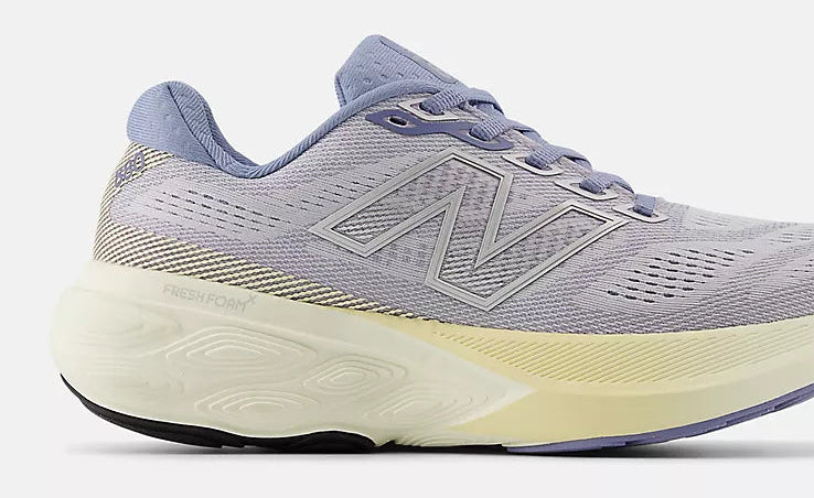 Gray running shoe with a white sole on a light gray background